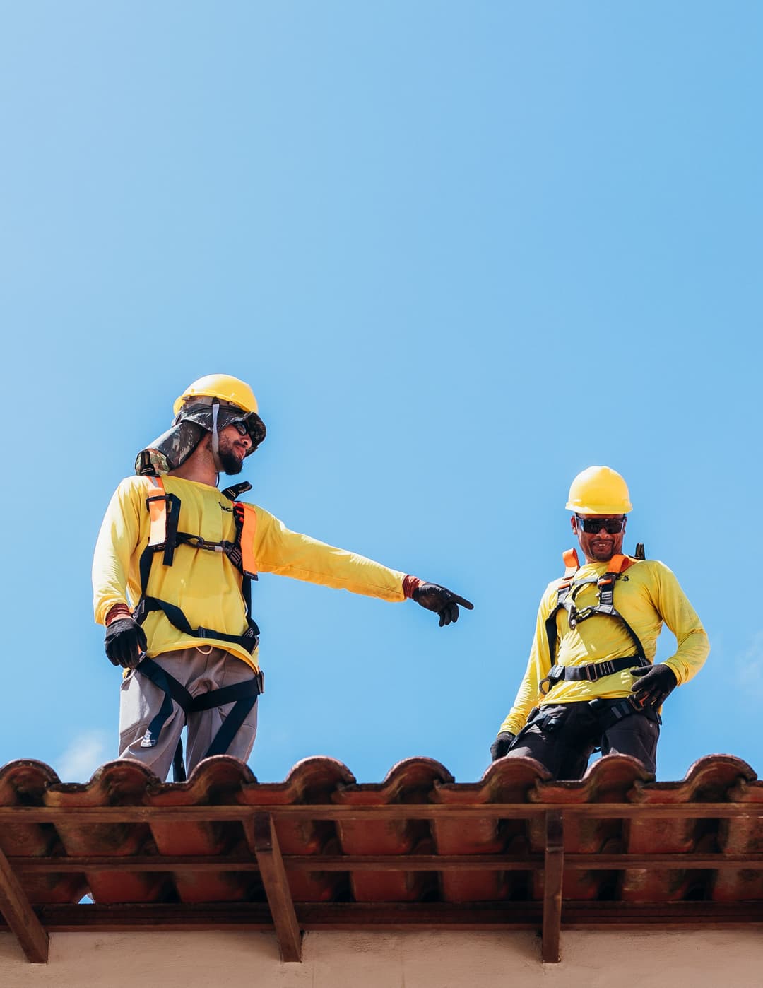 roofing crew inspecting a tile roof on-site